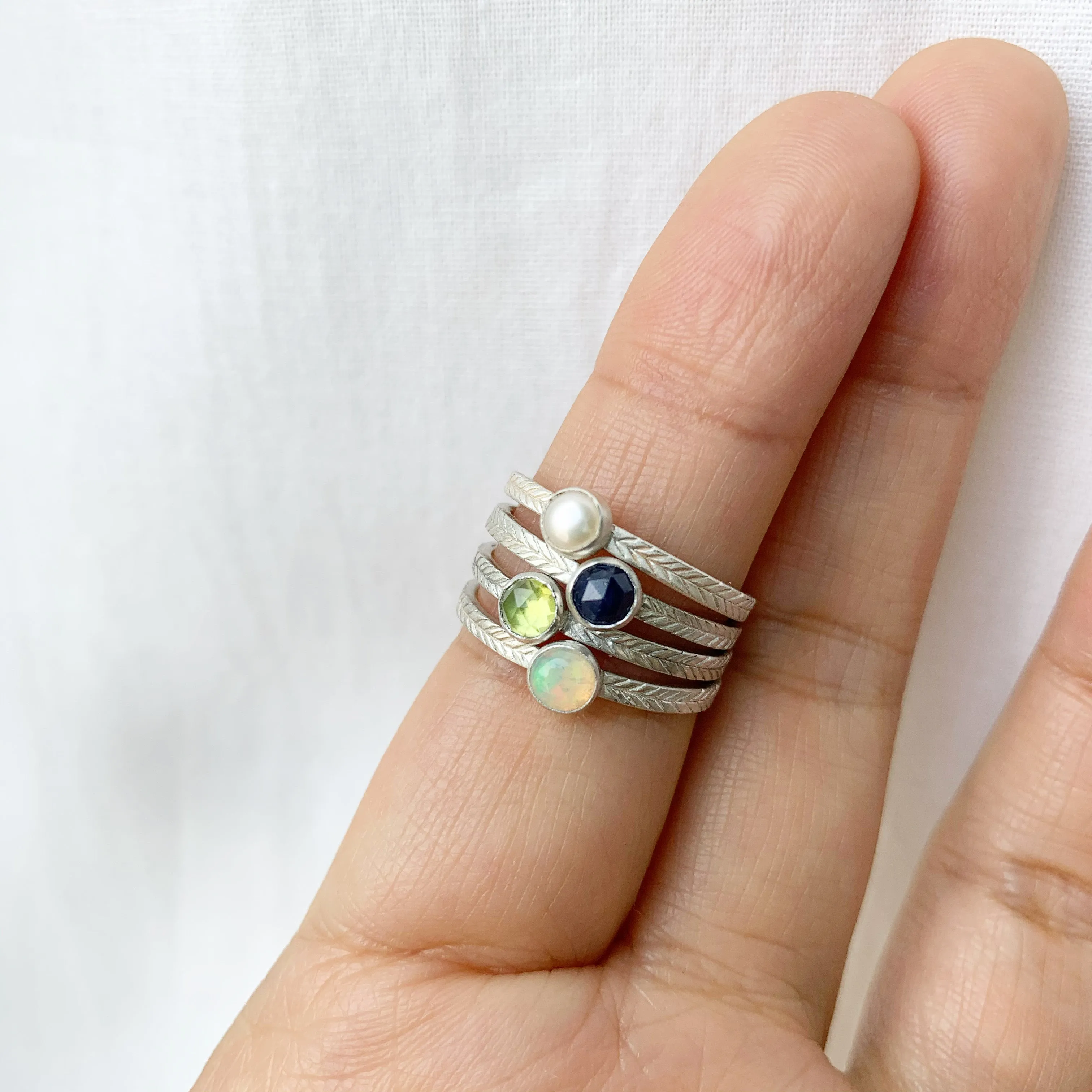 Opal ring with hand-carved feather textures